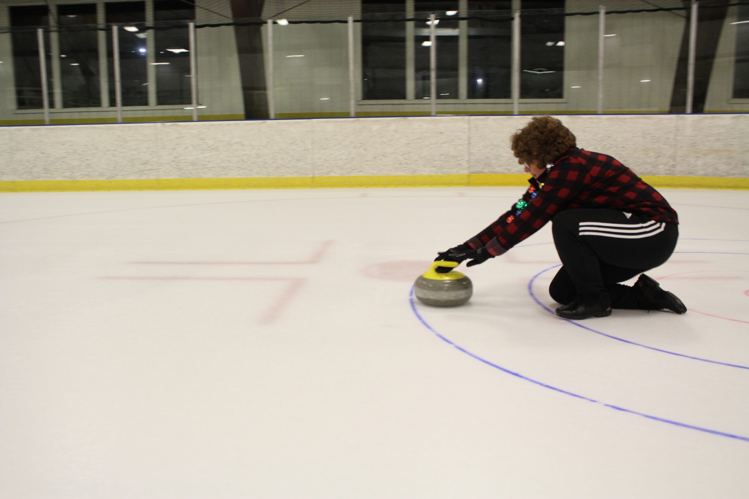 Heather Barclay tests the ice conditions at the at the Morgantown Ice Arena Saturday night by curling a stone down the ice.