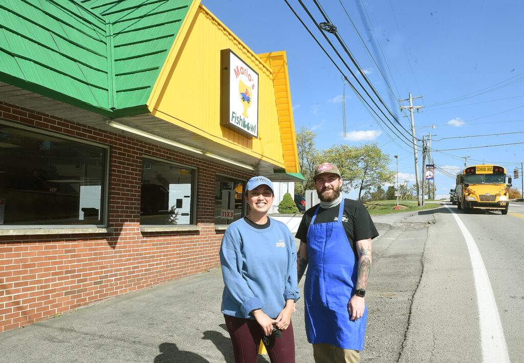 owner and gm in front of Mario's Fish Bowl in Westover