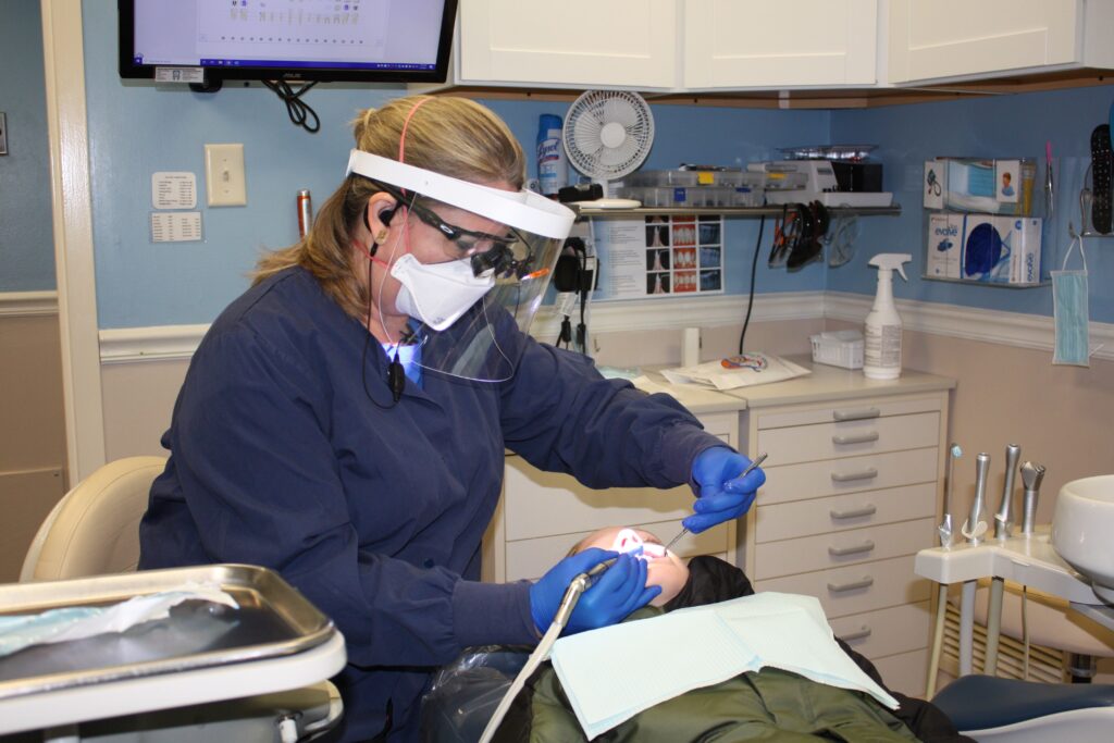 dental assistant Stacy Croston examines patient Mikhail Conrad
