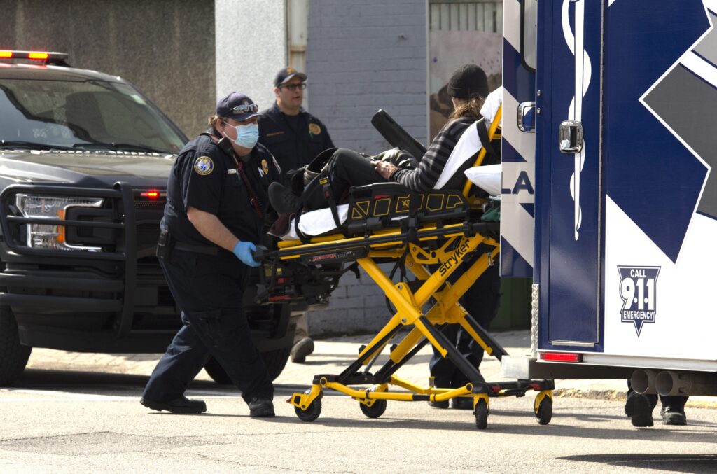 Stabbing victim wheeled into ambulance
